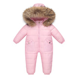 The Baby Wears White Eiderdown Over A Onesie And Down Jacket